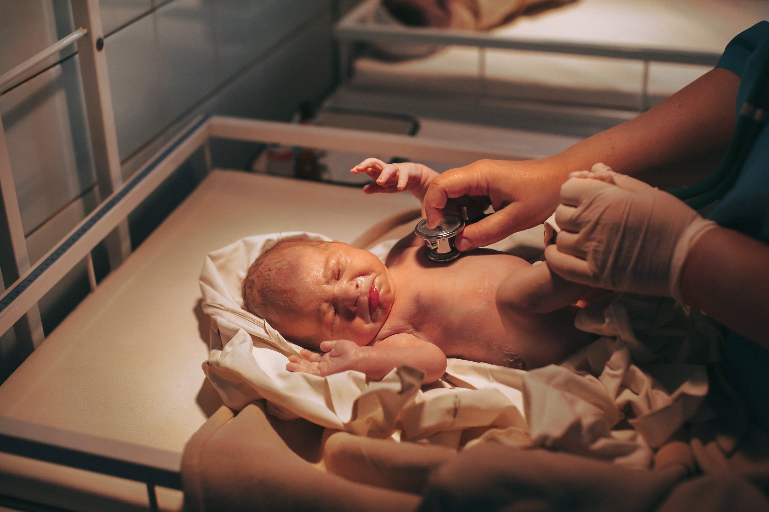 doctor-paediatrician-examining-baby-in-c