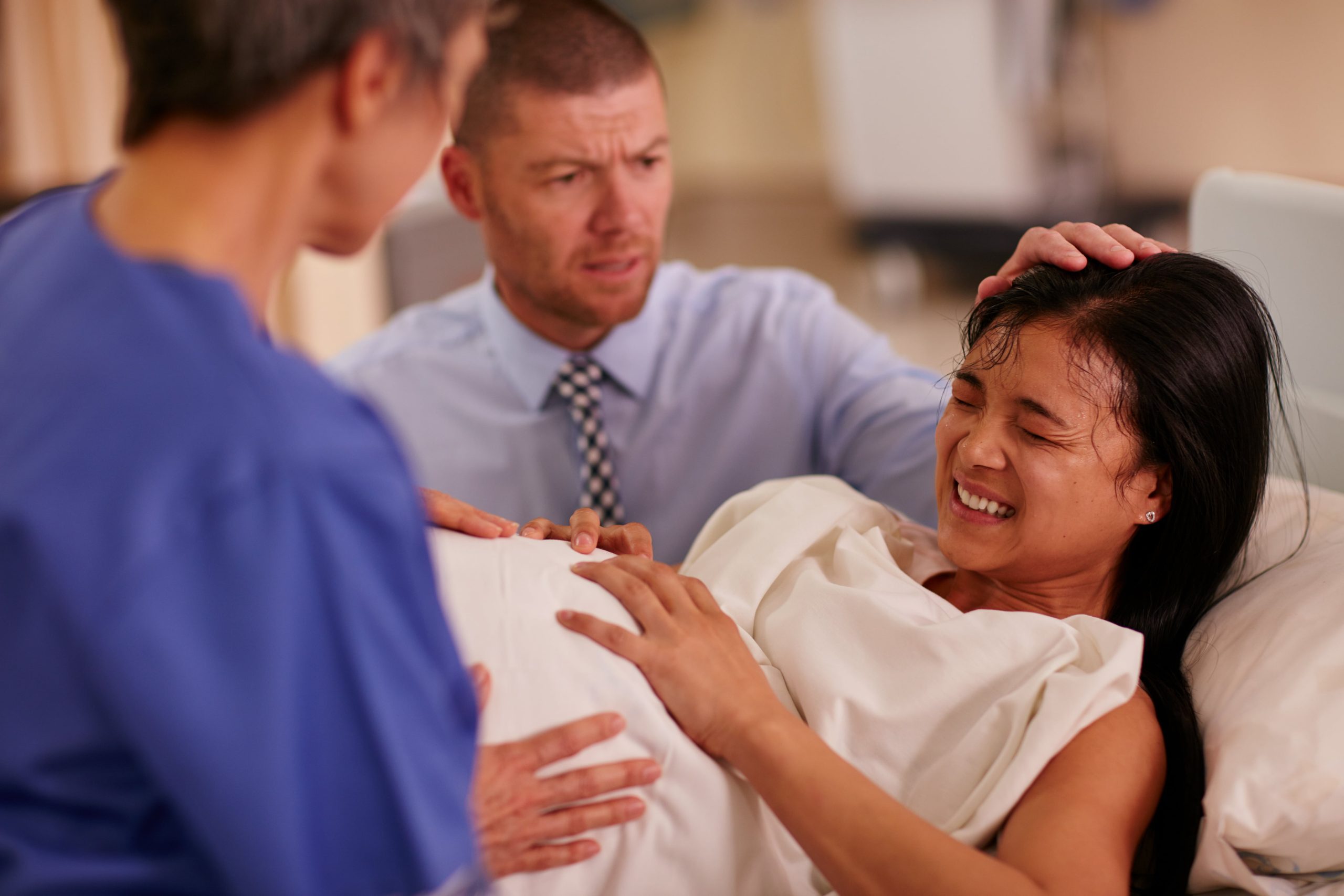 shot-of-a-young-woman-giving-birth-with-